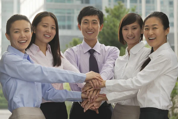 Business people with hands on top of each other — Stock Photo, Image