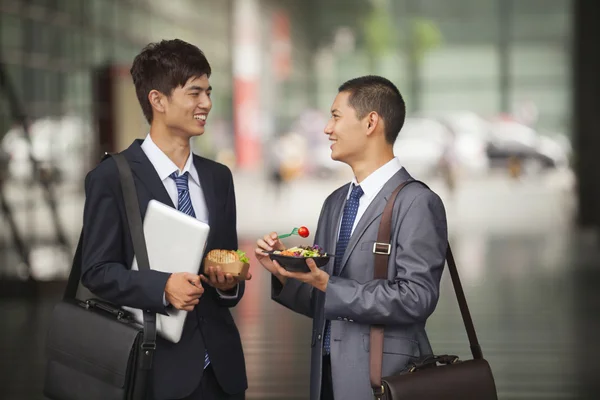 Businessmen talking and having a lunch outdoor — Stock Photo, Image