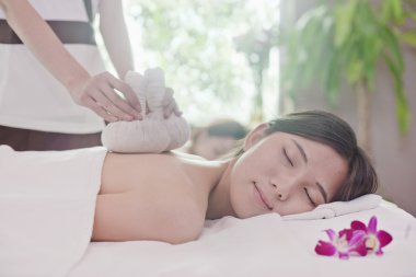 Women Receiving Herbal Massage clipart