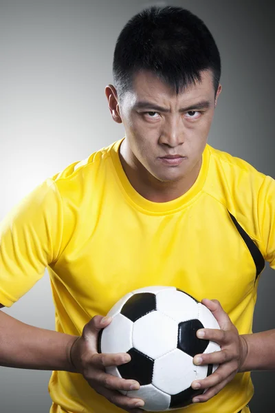 Soccer player holding a soccer ball — Stock Photo, Image