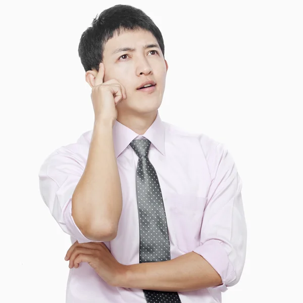 Young man with hand on face thinking — Stock Photo, Image