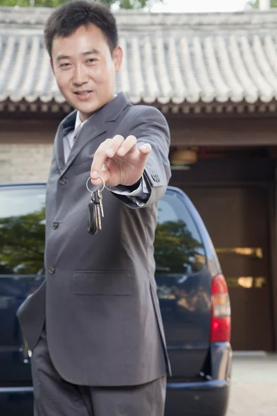 Businessman Holding Out Car Keys — Stock Photo, Image