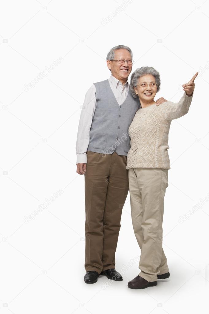 Senior couple pointing