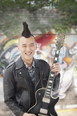 Man with punk Mohawk holding guitar clipart