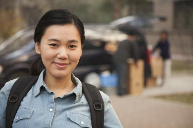 Student portrait in front of dormitory at college clipart