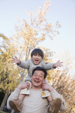 Grandfather and Grandson Playing in the Park