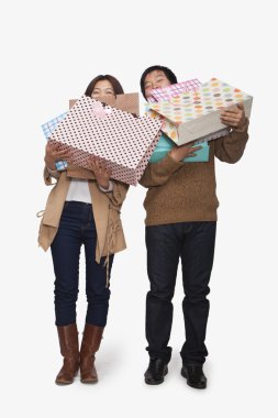 Couple carrying shopping bags clipart