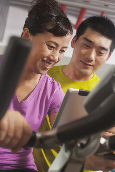 Woman exercising on the exercise bike — Stock Photo, Image