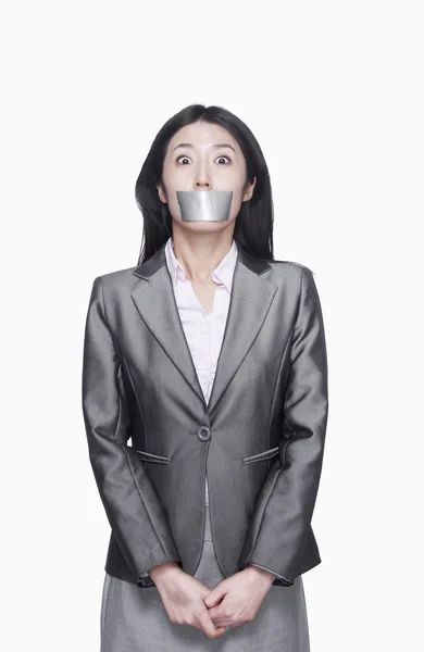 Businesswoman with her mouth caver with duct tape — Stock Photo, Image