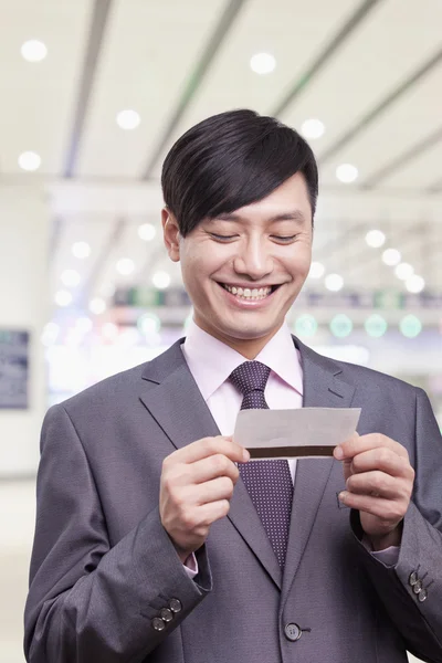 Businessman looking at airplane ticket — Stock Photo, Image