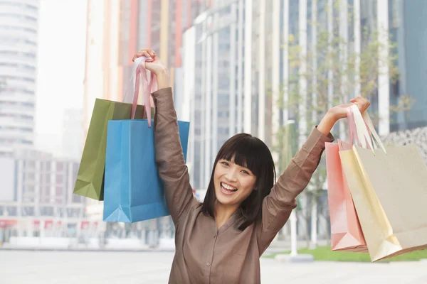 Woman holding shopping bags up — Stock Photo, Image