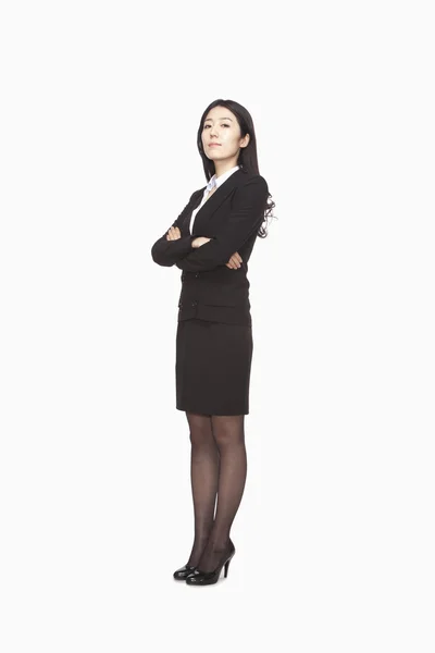 Businesswoman standing with arms crossed — Stock Photo, Image