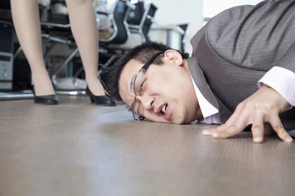 Businessman with face on the floor — Stock Photo, Image