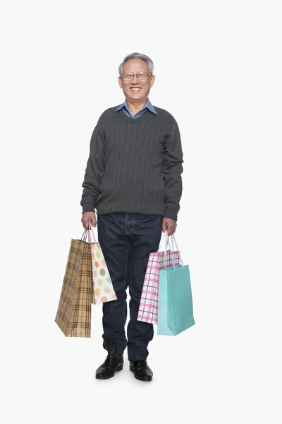 Senior man with shopping bags — Stock Photo, Image