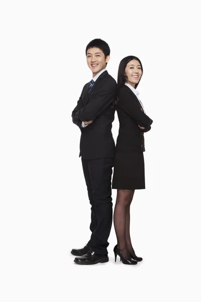 Businessman and businesswoman standing back to back — Stock Photo, Image