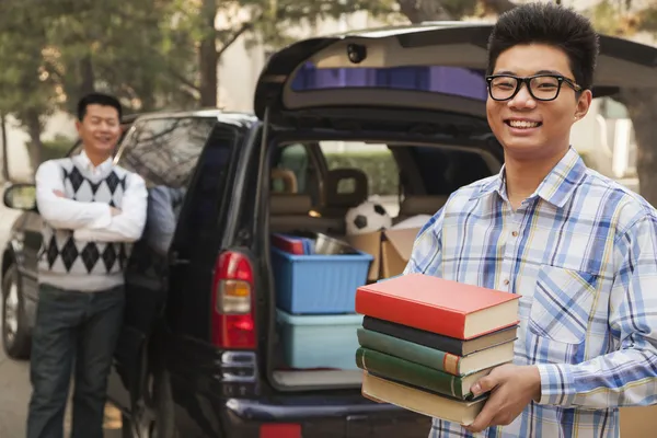 Boy unpacking car for college Royalty Free Stock Images