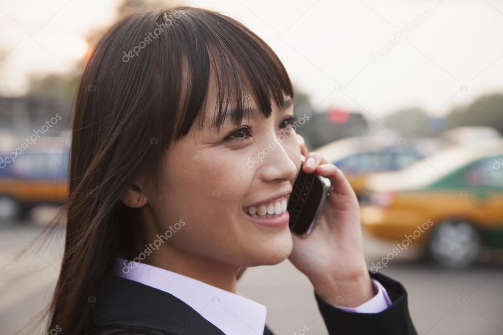 Businesswoman using the phone outside