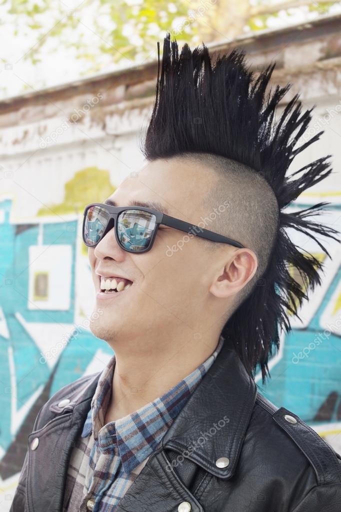 Young man with punk Mohawk smiling
