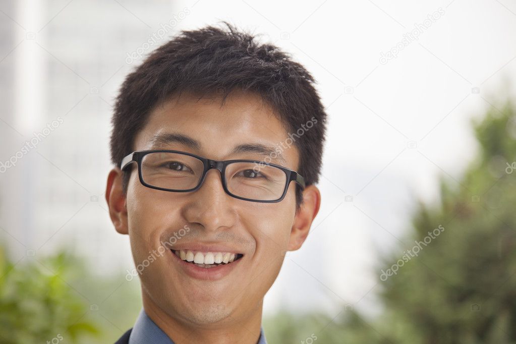 Businessman smiling in the park
