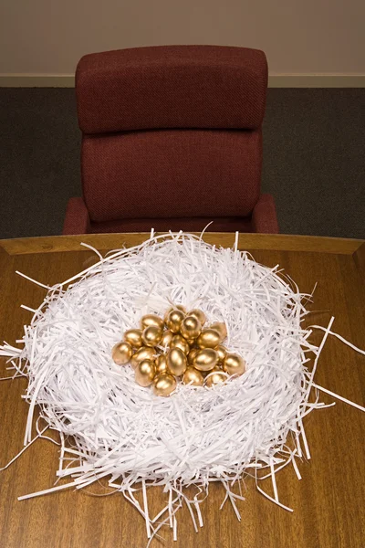 Golden eggs in a paper nest — Stock Photo, Image