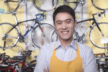 Male mechanic in bicycle store clipart
