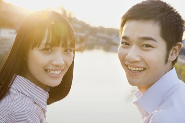 Couple Looking at the Camera by a River — Stock Photo, Image