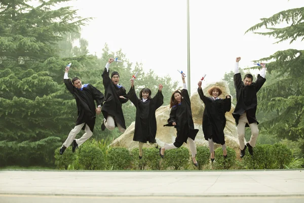 Group of Graduates Jumping — Stock Photo, Image