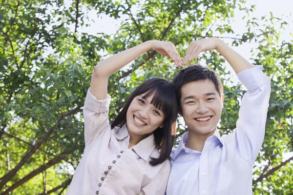 Couple Making a Heart Shape with Their Arms — Stock Photo, Image