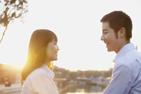 Couple Looking at the Camera by a River — Stock Photo, Image