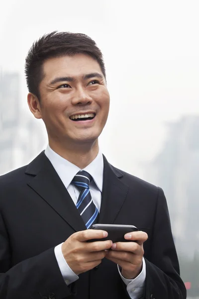 Joven empresario usando un teléfono inteligente — Stockfoto