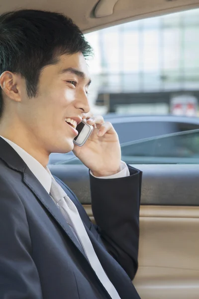 Businessman in Back Seat of Car on the Phone — Stock Photo, Image