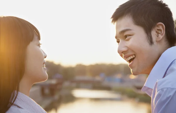 Couple Looking at the Camera by a River — Stock Photo, Image