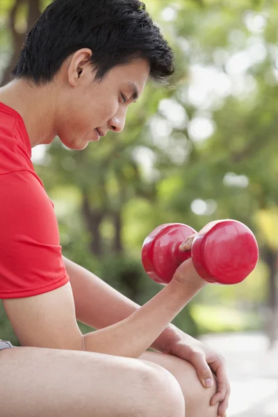 Young Man exercising with Dumbbell — Stock Photo, Image