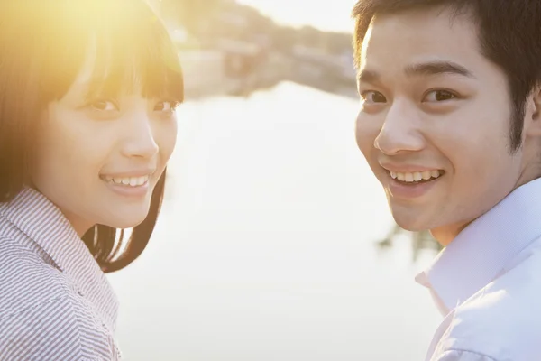 Couple Looking at the Camera by a River — Stock Photo, Image