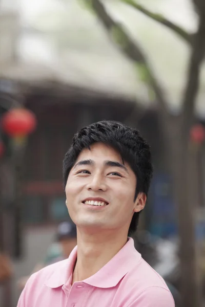 Fiatal férfi mosolyogva szabadban — Stock Fotó