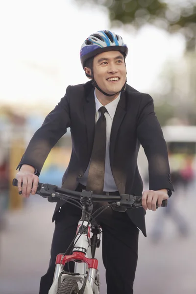 Businessman riding a bicycle — Stock Photo, Image