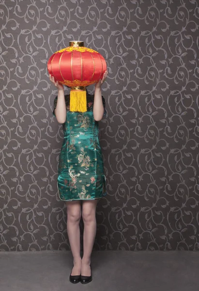 Woman covering her face with a Chinese lantern — Stock Photo, Image