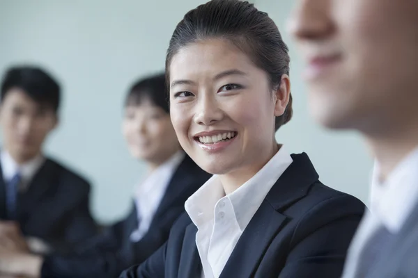 Four Business people sitting in a row — Stock Photo, Image