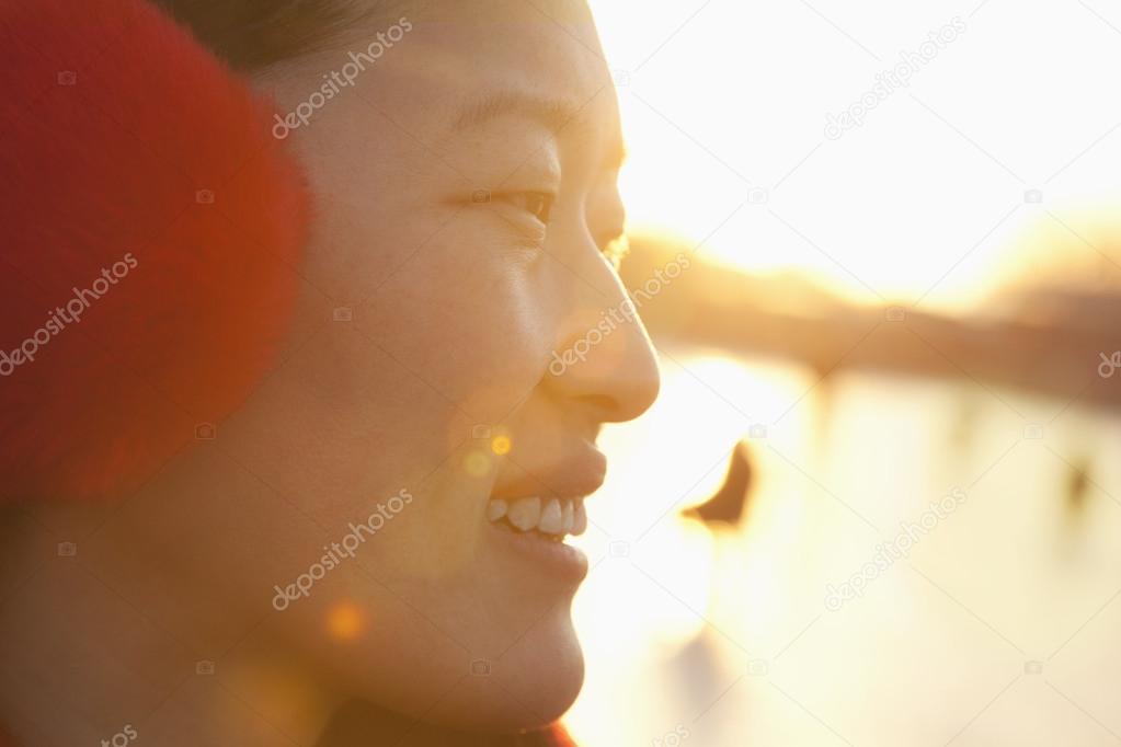 Young Woman at Sunset on Ice Rink