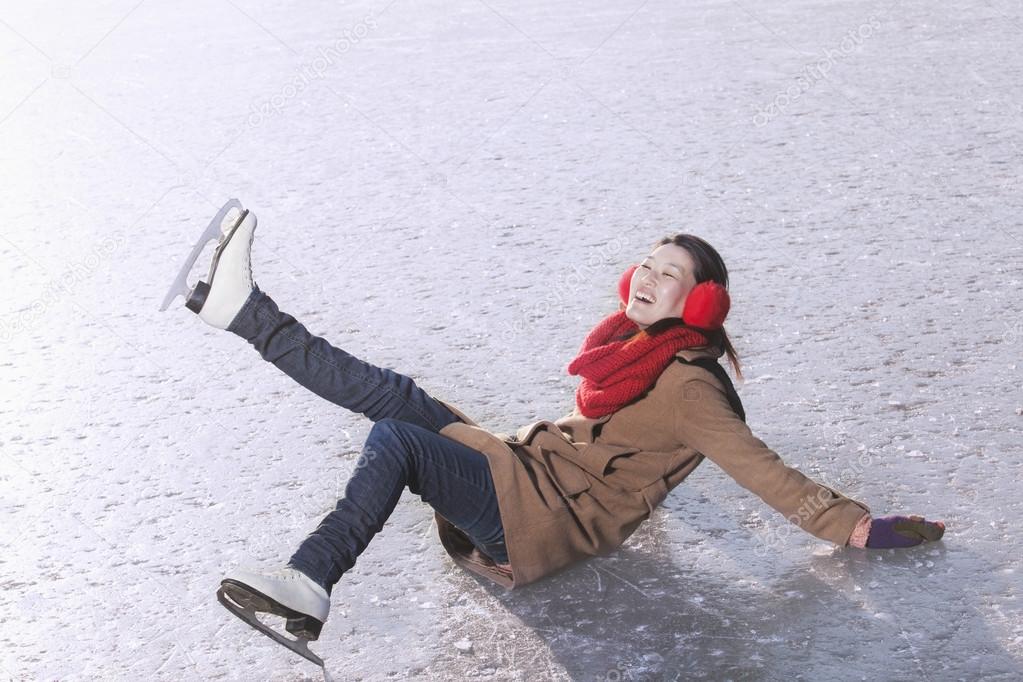 Woman Falling While Ice Skating