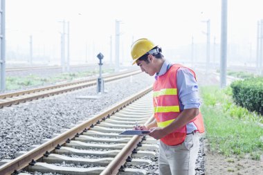Railroad worker checking the railroad tracks