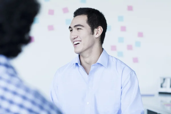 Businessman laughing and talking in the office — Stock Photo, Image