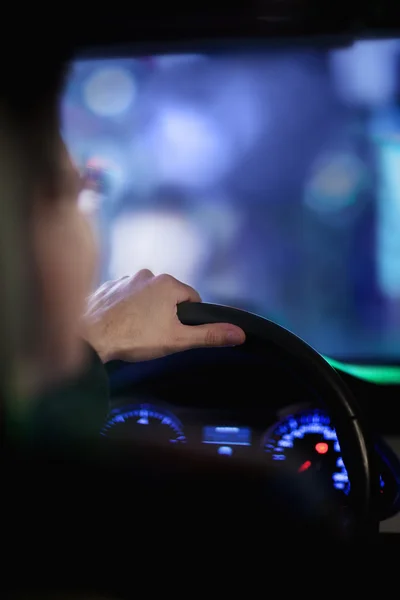 Businessman driving at night in the city — Stock Photo, Image