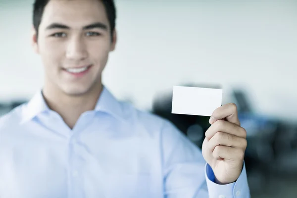 Businessman holding business card to the camera — Stock Photo, Image