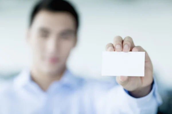 Businessman holding business card to the camera — Stock Photo, Image