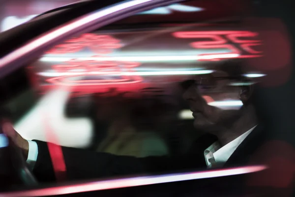 Businessman driving at night — Stock Photo, Image