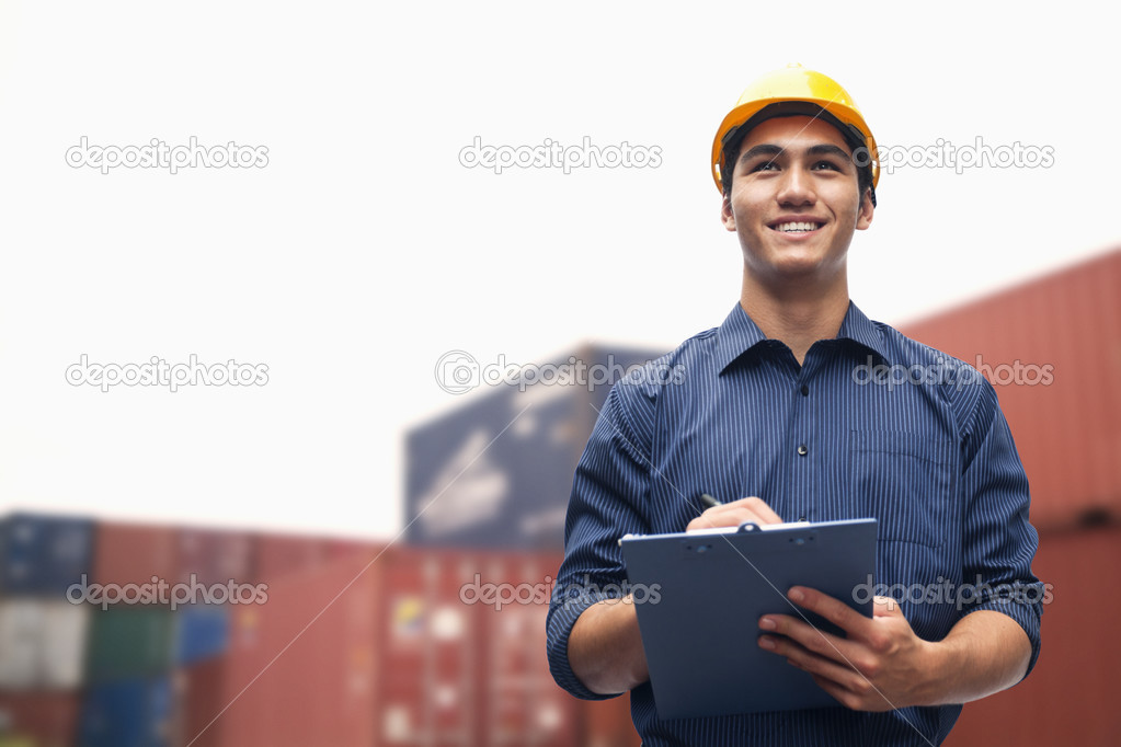 Engineer in a shipping yard examining cargo — Stock Photo © XiXinXing 36644603