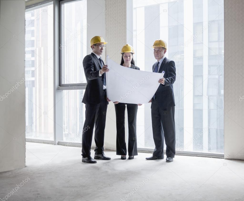 Architects examining a blueprint