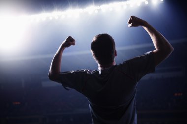 Soccer player with arms raised cheering clipart