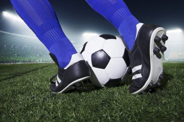 Feet kicking the soccer ball clipart